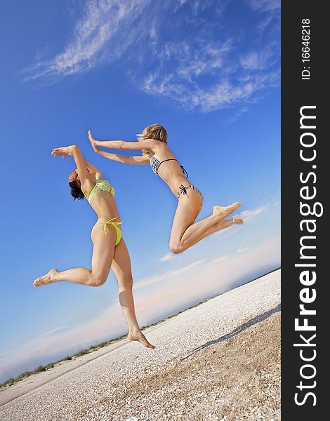 Girls jumping on a beach