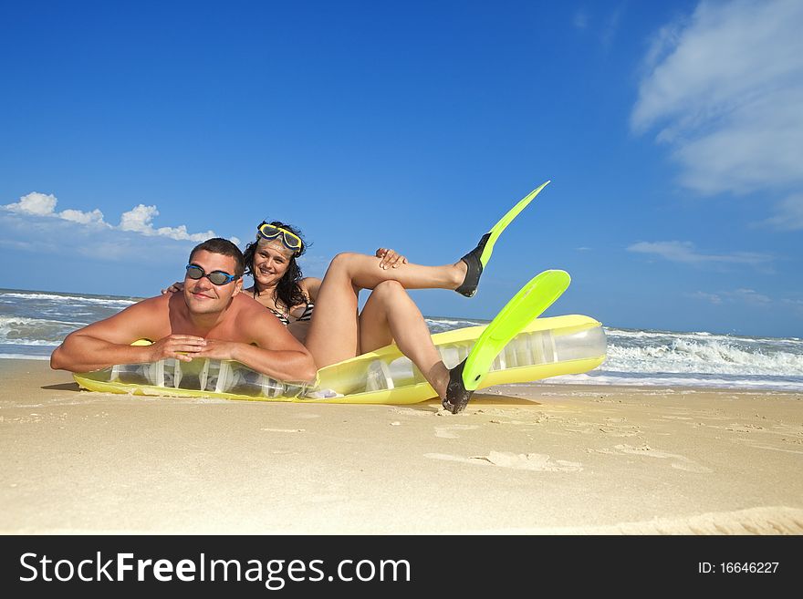 Couple enjoying on an inflatable beach mattress