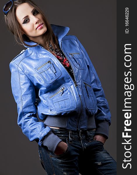 young woman with blue sunglasses, jeans and leather jacket