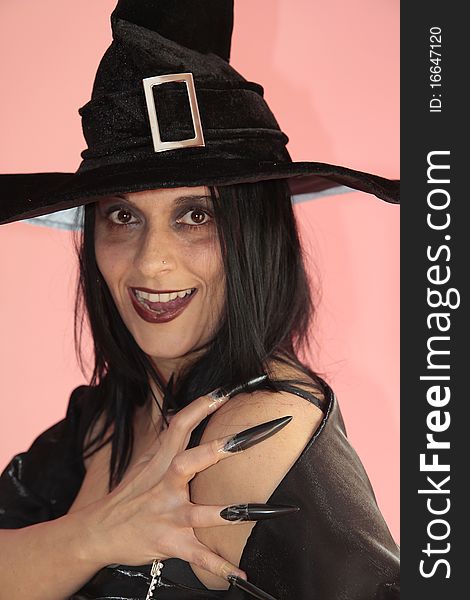 A beautiful witch halloween dark clothes and makeup. A beautiful witch halloween dark clothes and makeup