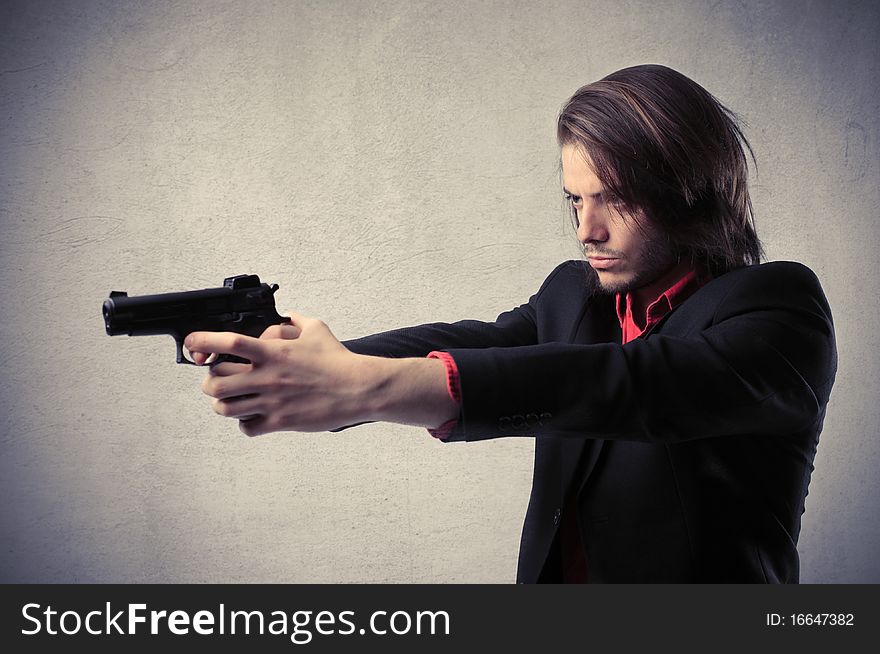 Young man holding a gun. Young man holding a gun