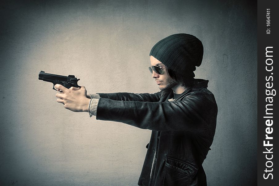 Young man holding a gun. Young man holding a gun