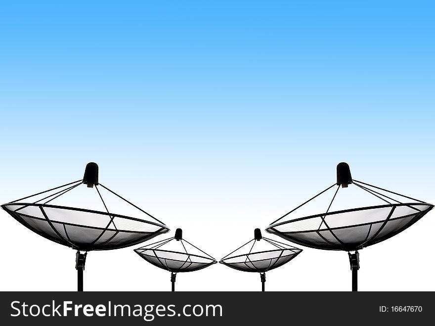 Background of the row of satellite dish silhouettes against the blue sky. The dishes are point to the space. Background of the row of satellite dish silhouettes against the blue sky. The dishes are point to the space.