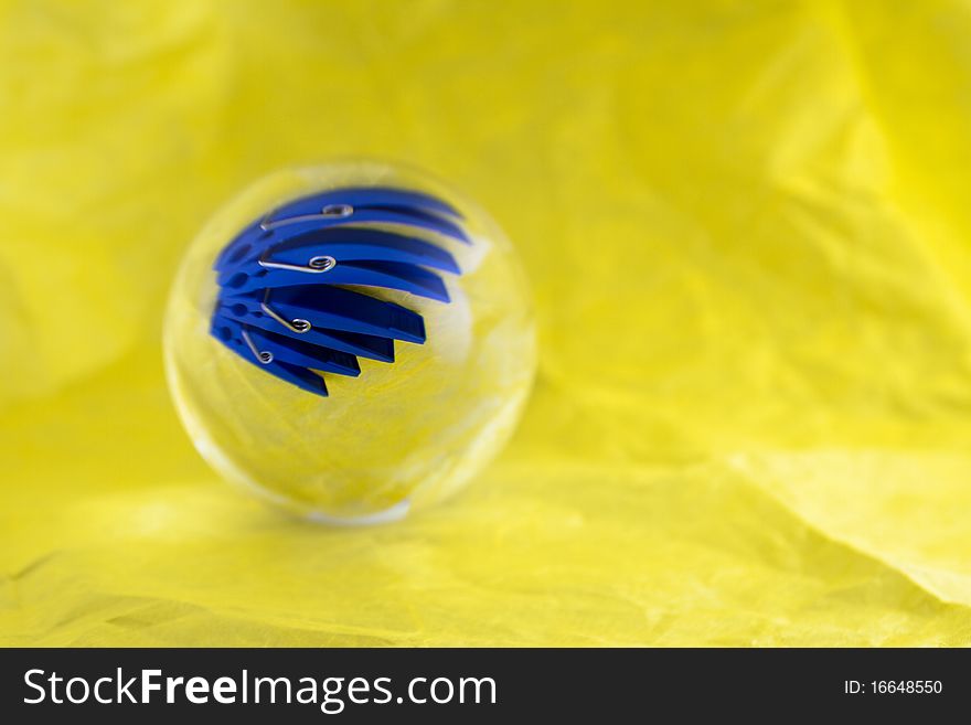 An optical illusion, four pegs seem to be in a glass ball. An optical illusion, four pegs seem to be in a glass ball