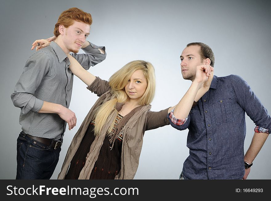 Two white men and one blonde woman dancing together. Two white men and one blonde woman dancing together