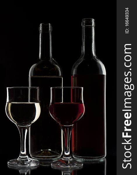 Red and white wine in two glasses and two bottles