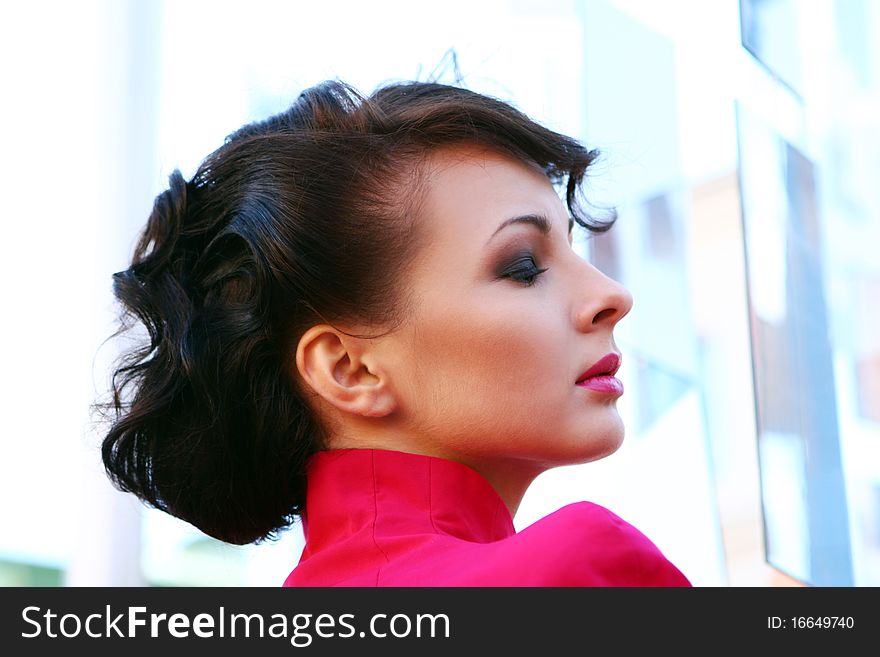 Young and attractive lady in black and pink dress.