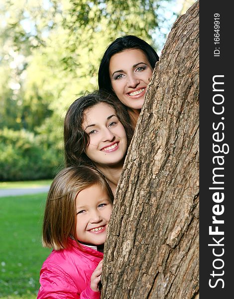 Young family taking healthy stroll through autumn park and have fun. Young family taking healthy stroll through autumn park and have fun