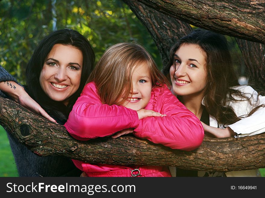 Young family taking healthy stroll through autumn park and have fun. Young family taking healthy stroll through autumn park and have fun