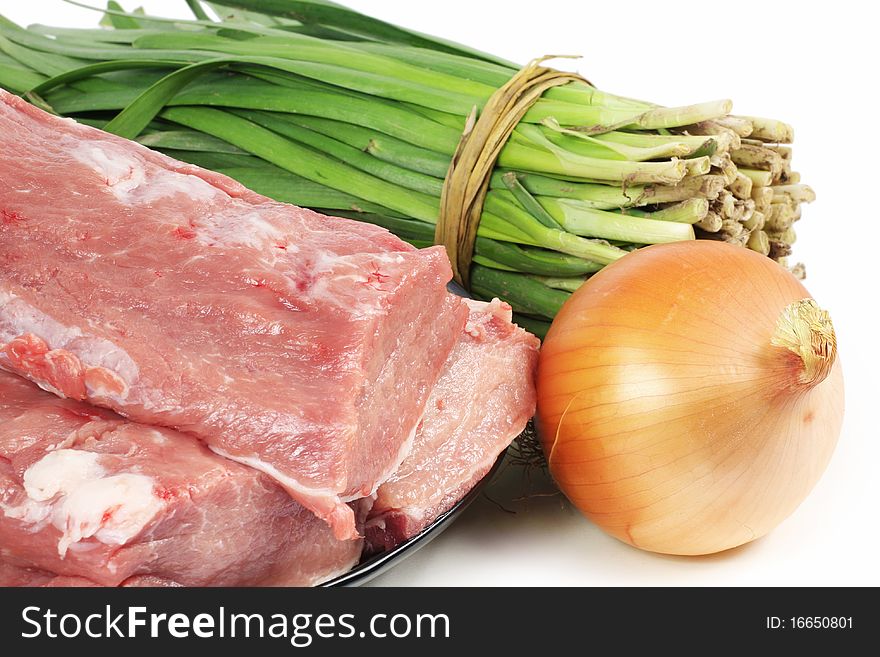 Tenderloin, leek, onion on a white background