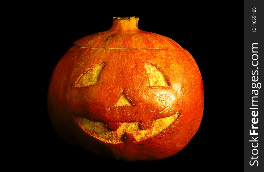 Halloween face cut out on fruit. Isolated on black. Halloween face cut out on fruit. Isolated on black