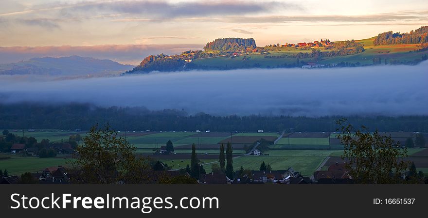 Band of fog in a valley at sunrise