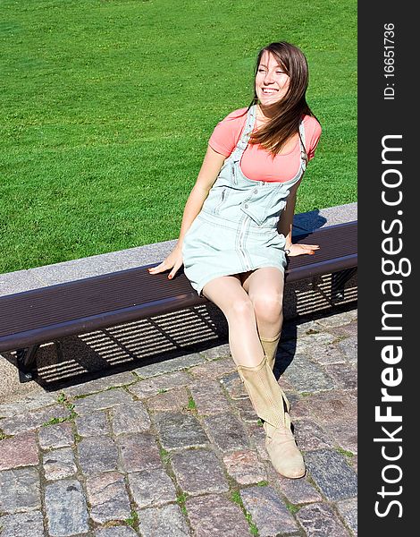 Young Attractive Girl Model Sitting On Bench