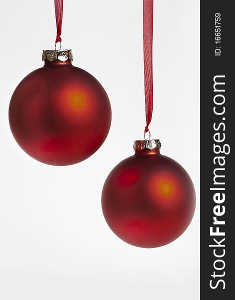 Christmas decoration of two red baubles on red ribbons. Christmas decoration of two red baubles on red ribbons