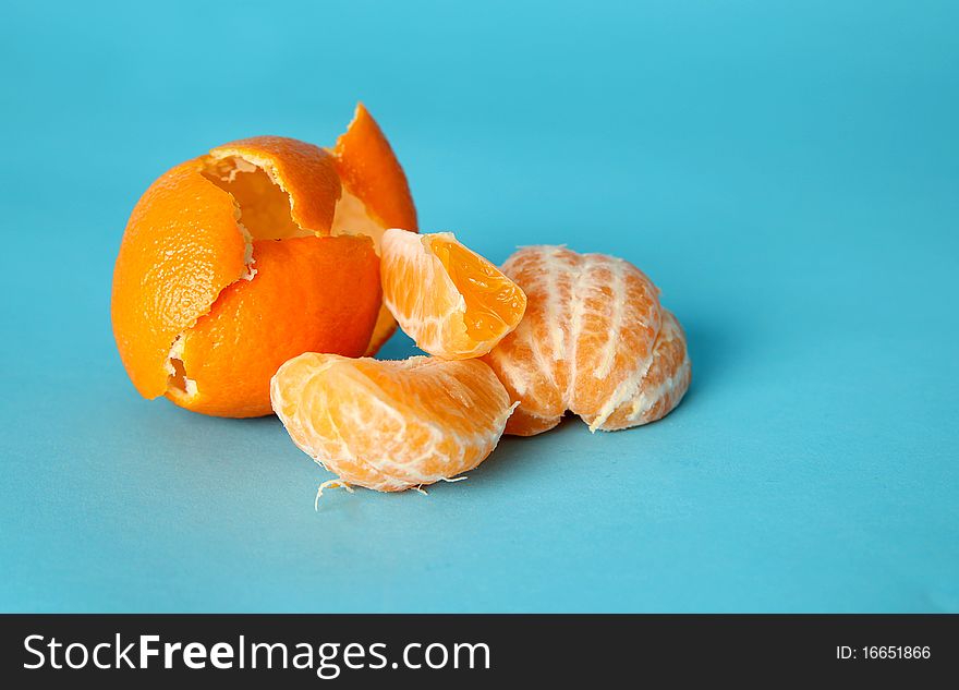 Peeled orange on blue background