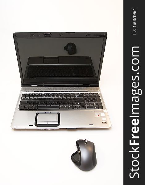 Laptop computer and computer mouse on white background. Laptop computer and computer mouse on white background