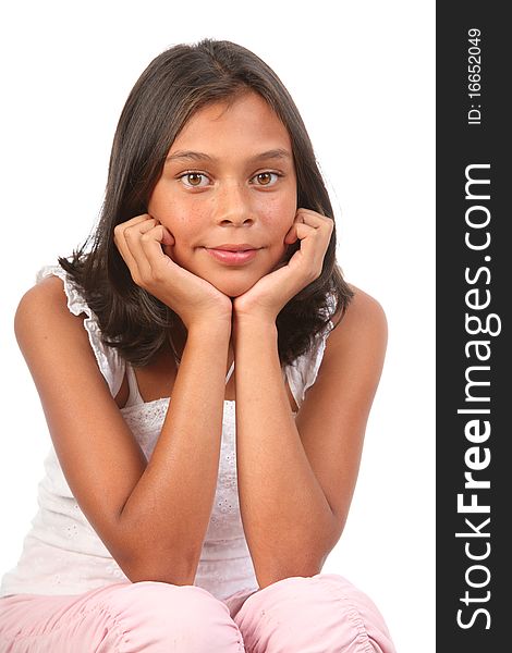 Studio portrait of young teenage girl, 13, sitting with elbows on knees and resting chin in hands - Canon 5D MKII. Studio portrait of young teenage girl, 13, sitting with elbows on knees and resting chin in hands - Canon 5D MKII