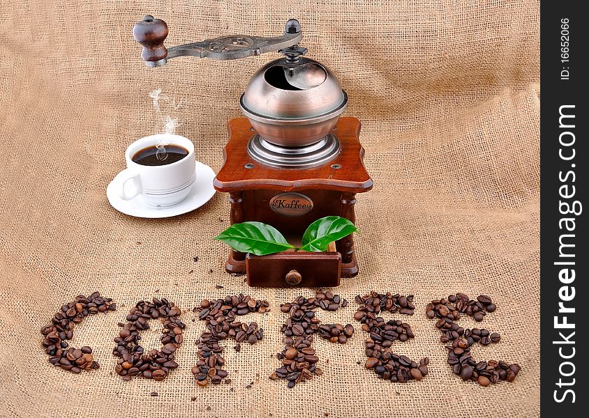 Vintage coffee grinder and sign coffe from coffee granules with coffee plant
