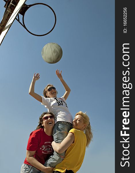 Basketball players throwing the ball in the basket outdoor. Basketball players throwing the ball in the basket outdoor