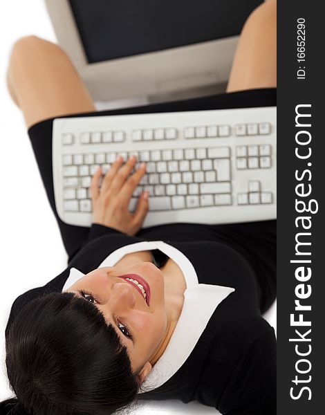 Smiling business woman with a keyboard looking at the camera. Top view