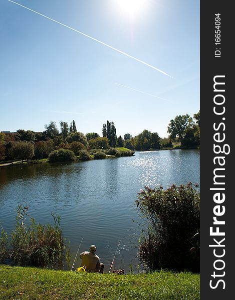 Man fishing in the city, small lake. Man fishing in the city, small lake