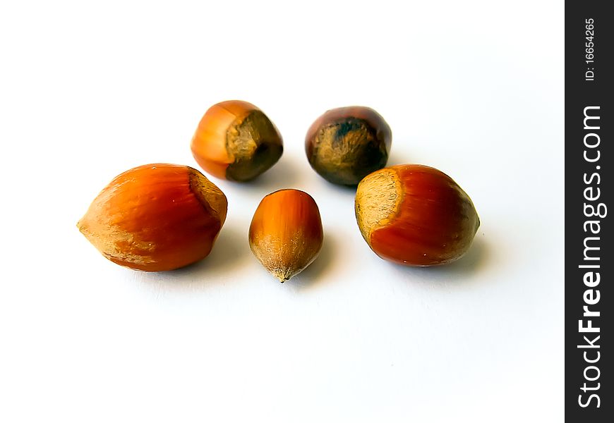 Heap of hazelnuts isolated over white background