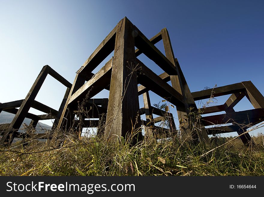 Big wooden chairs against the blue sky.