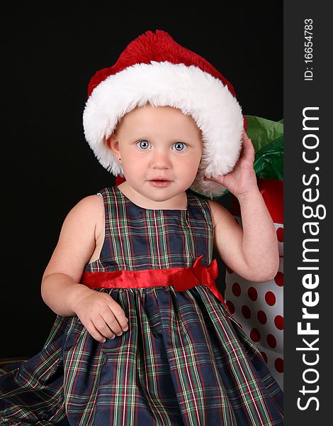 Cute caucasian toddler wearing a fluffy christmas hat. Cute caucasian toddler wearing a fluffy christmas hat