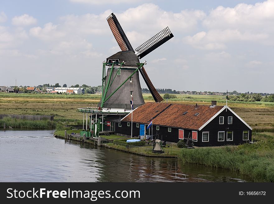 Dutch Windmill On A Canals Edge