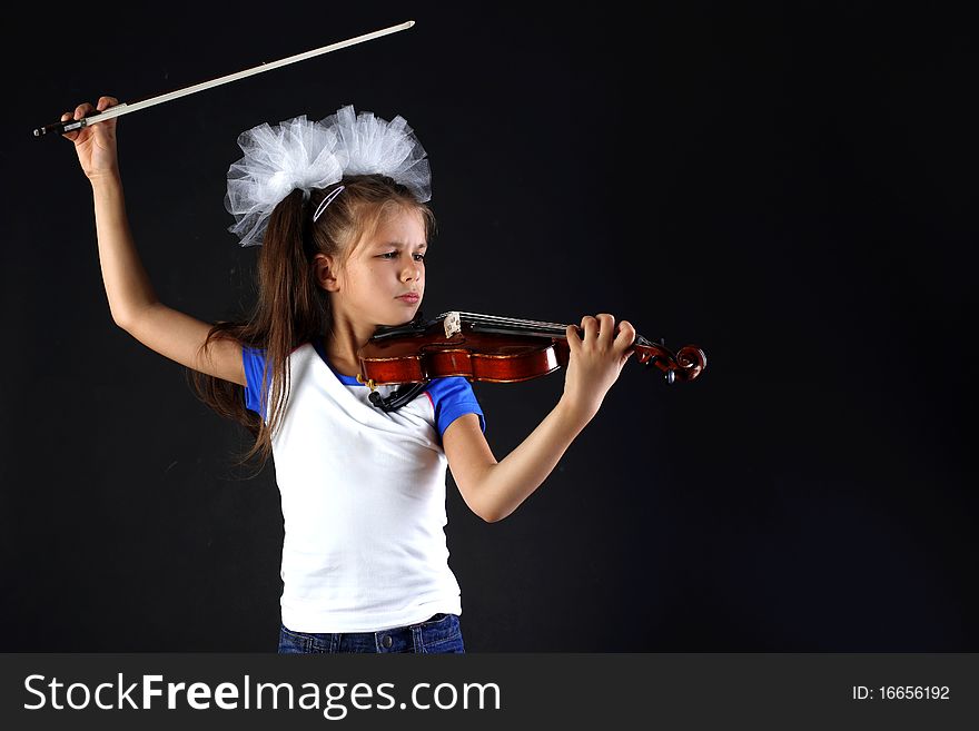 Little girl playing in violin. Little girl playing in violin