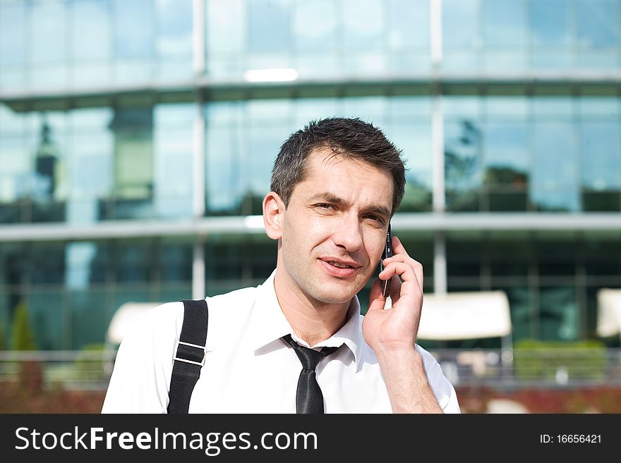 Manager speak on phone across office building