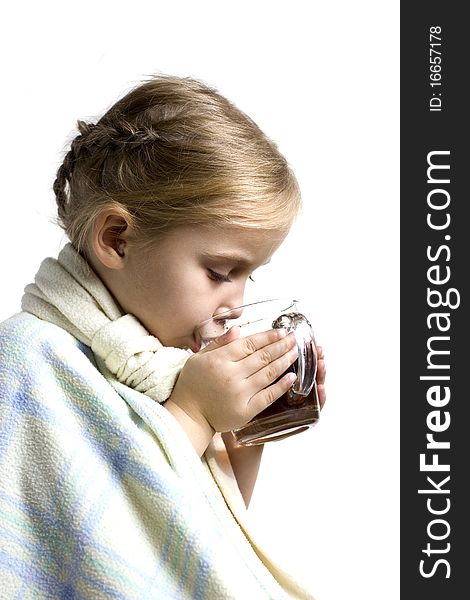 Child in scarf is ill with cup of tea. Child in scarf is ill with cup of tea