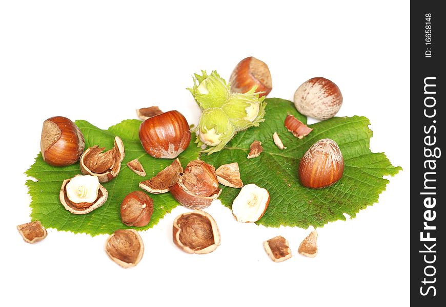 Hazelnuts with leaves and shell in the background