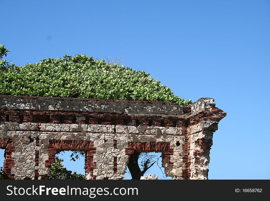 Section of a lighthouse ruin wall with tree against a blue sky near the town of Aguadilla, Puerto Rico. Section of a lighthouse ruin wall with tree against a blue sky near the town of Aguadilla, Puerto Rico.