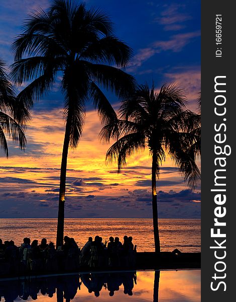 Group of people having diner on the beach at a sunset. Group of people having diner on the beach at a sunset