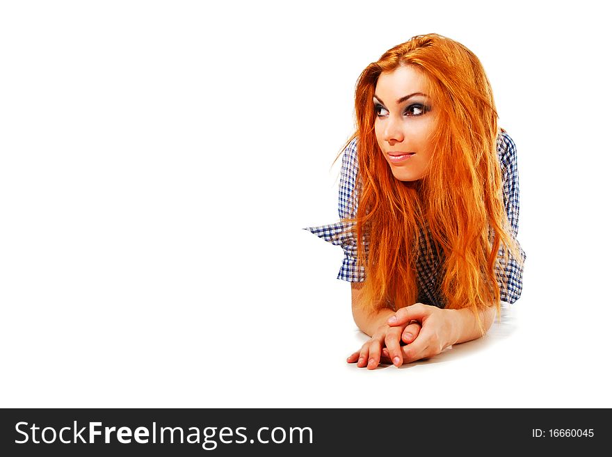 Picture of a attractive young smiling girl in shirt which lie on floor. Isolated on white.