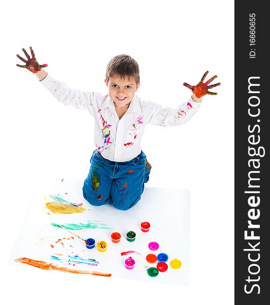 Adorable 3 year old boy covered in bright paint.