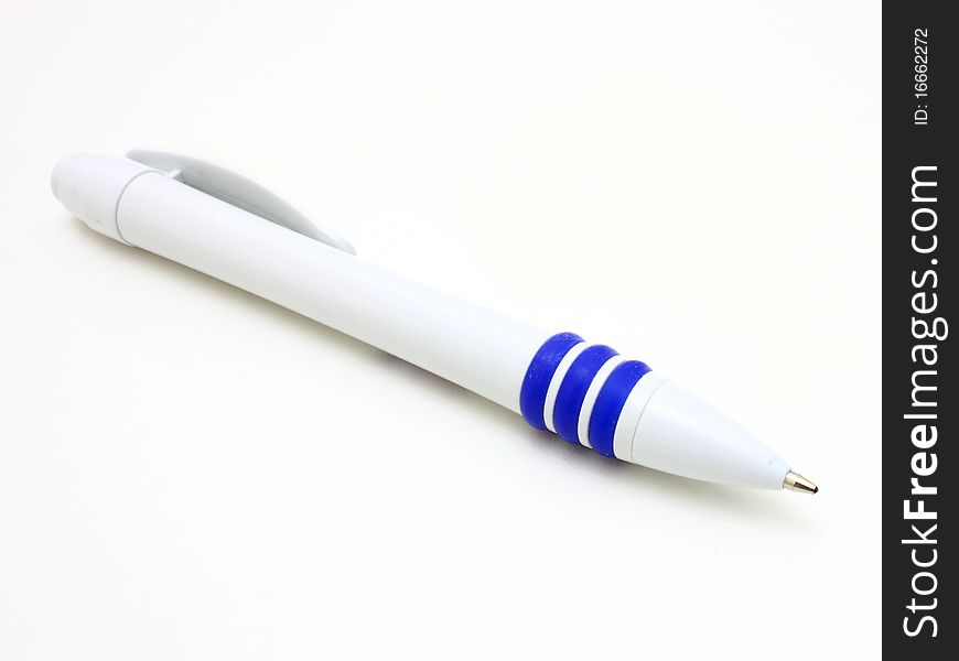 The dark blue ball pen lies on a white background