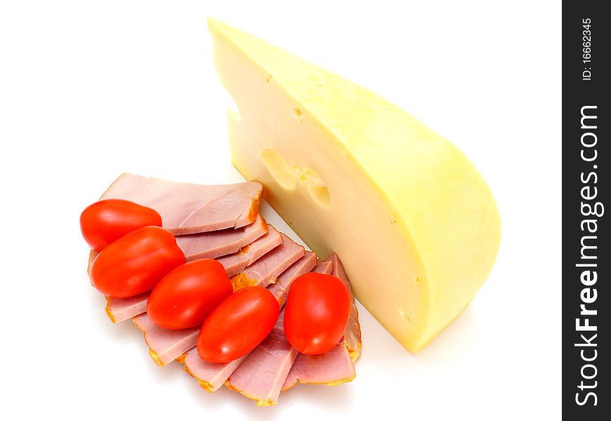 Cheese with holes and red tomatoes lie on a white background