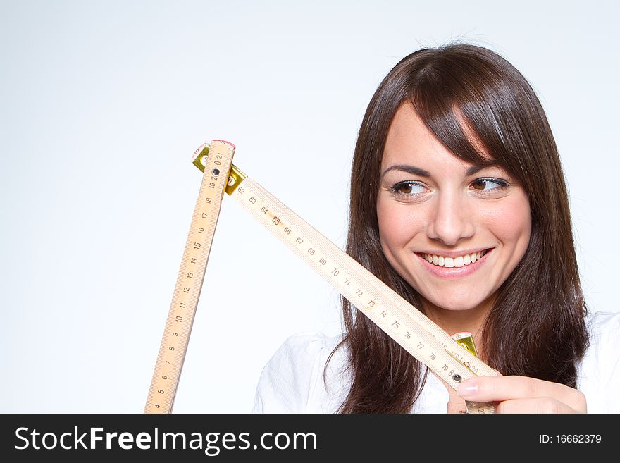 Young woman holding a yardstick. Young woman holding a yardstick