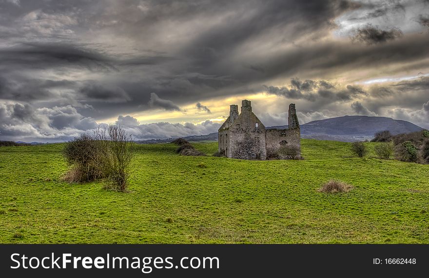 An Irish landscape with an old derelict castle in a very green field and very dramatic skies. An Irish landscape with an old derelict castle in a very green field and very dramatic skies.