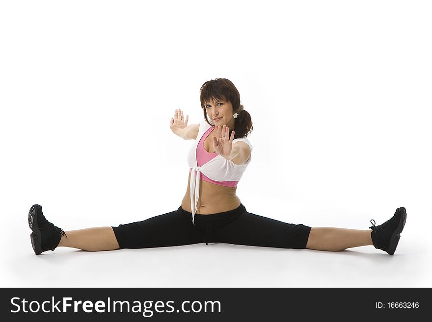 Middle aged woman doing stretching exercises on the foor