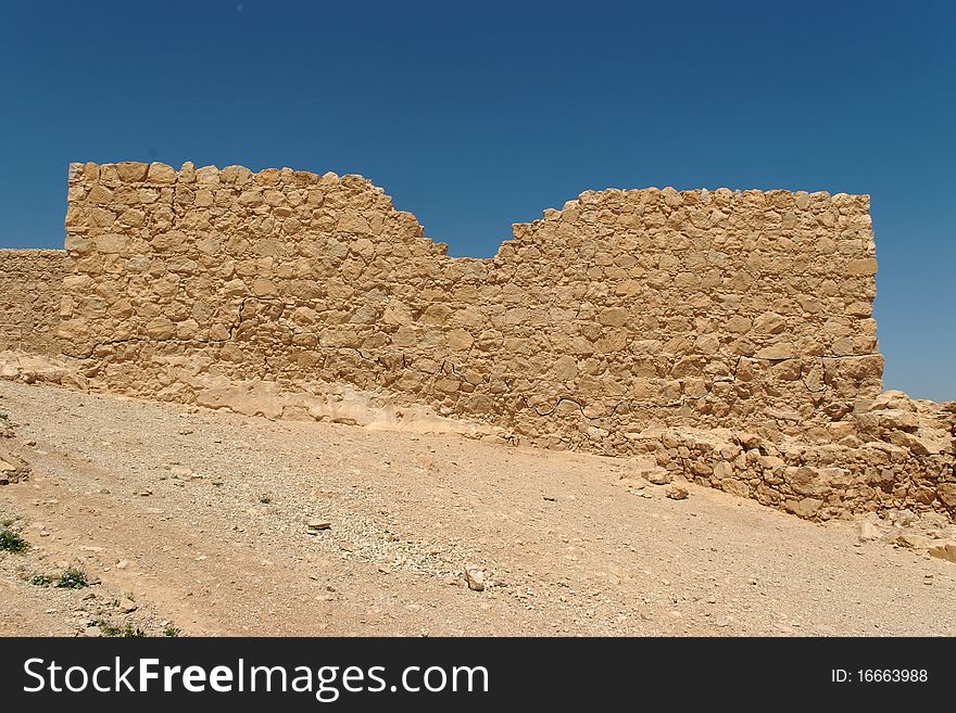 Jagged wall of ancient fortress  in the desert