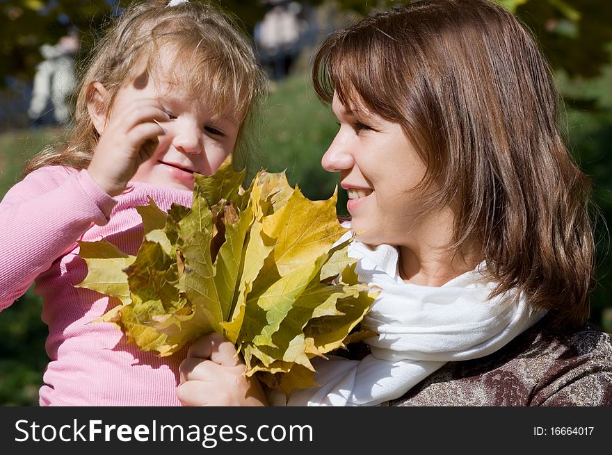 Happy family in autumn park outdoor