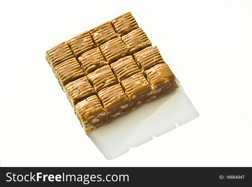 Brown sweet with nuts on a white background