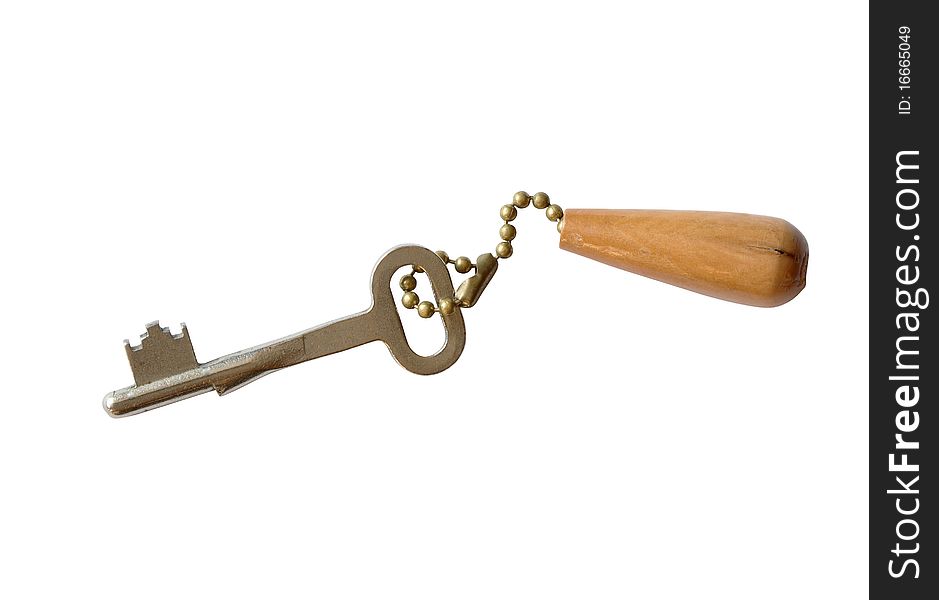 Key with wooden trinket isolated on white background with clipping path. Key with wooden trinket isolated on white background with clipping path