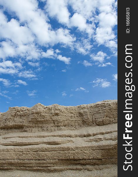 The sand that pile up to is , and have the background is the sky. The sand that pile up to is , and have the background is the sky