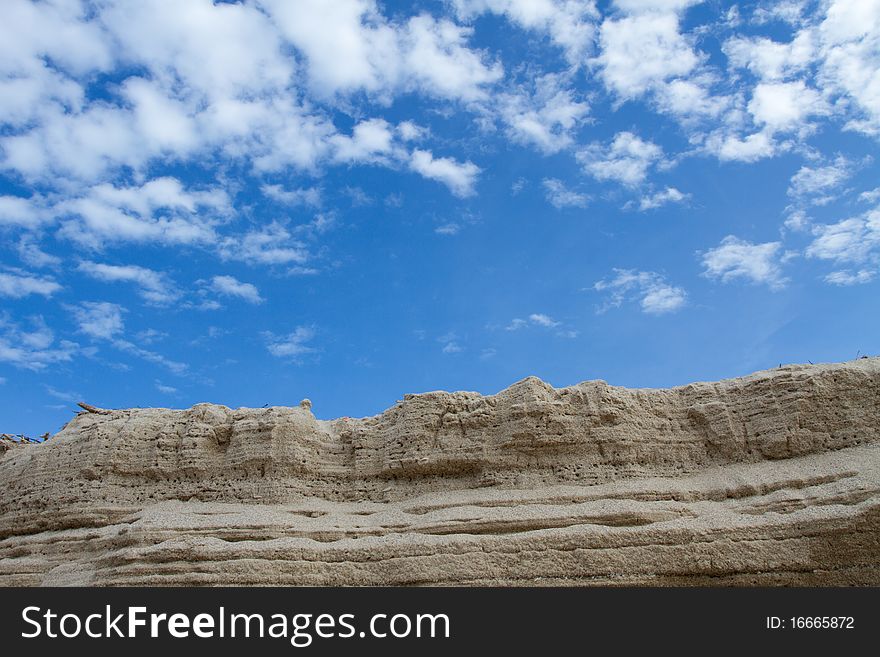 The sand that pile up to is , and have the background is the sky. The sand that pile up to is , and have the background is the sky