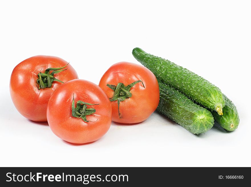 Tomato and cucumber on white background