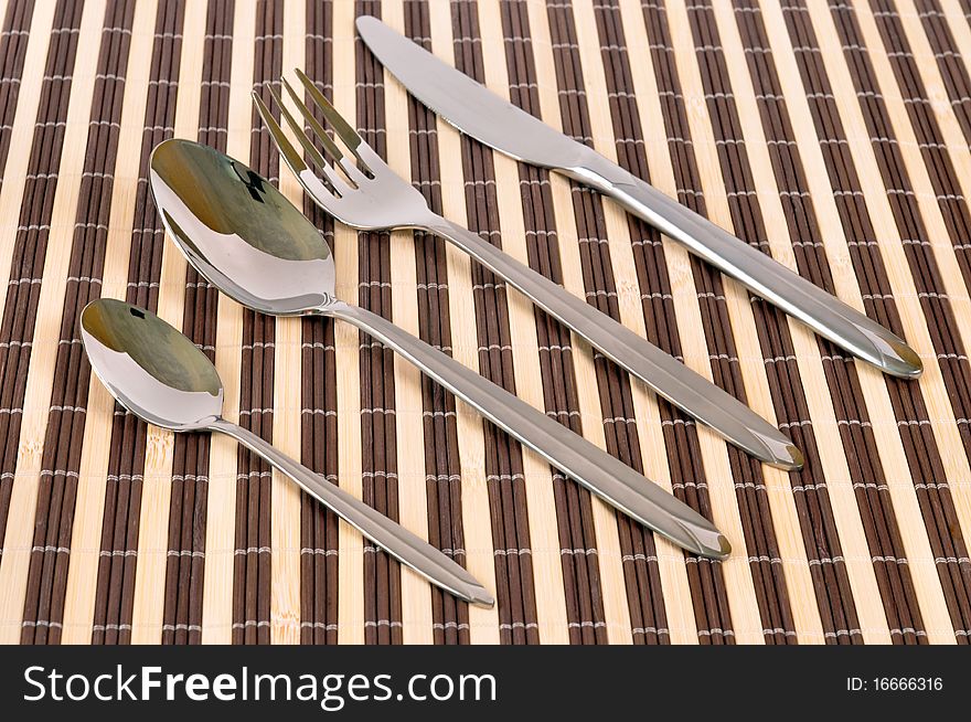 Flatware set: fork, knife spoon - on mad background